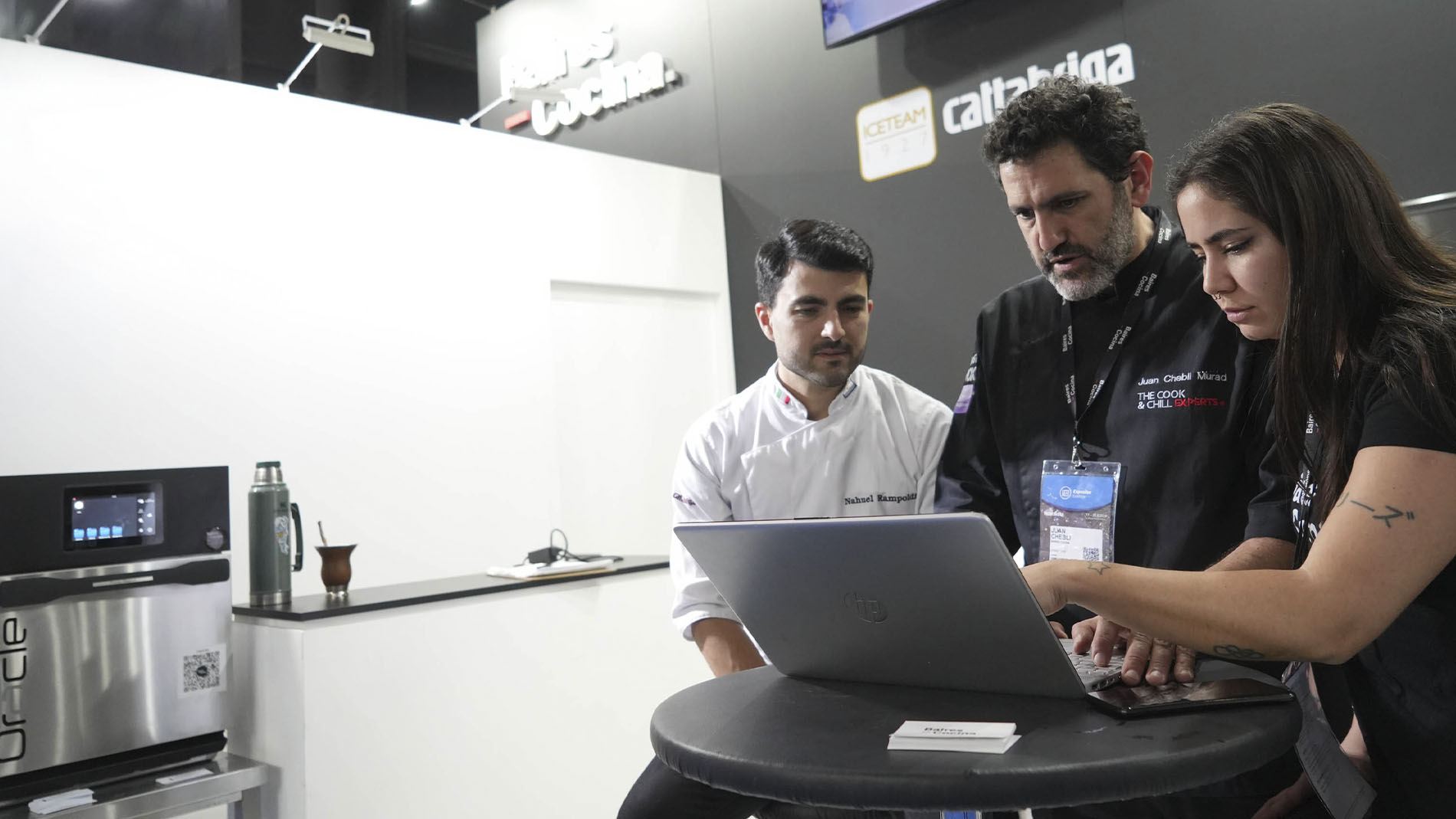 photo of exhibitor and visitors interacting at a stand